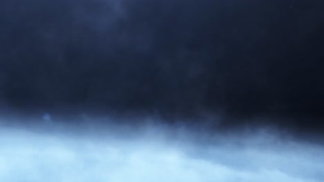 thunderstorm over white clouds in dark sky