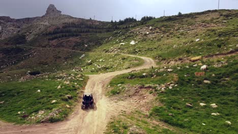 traveling quad vehicle on dirt road in the mountains near bakhaoun town in lebanon