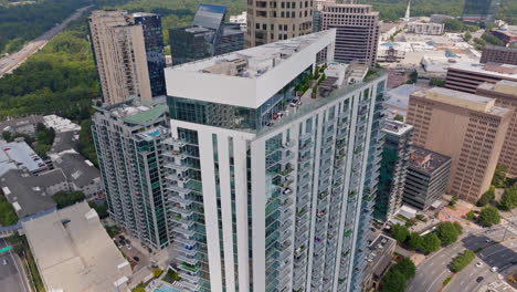 luxury apartments on tower with rooftop and cars on road in atlanta