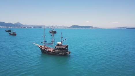 4K-shot-of-Aerial-Drone-Surrounding-Pirate-Boat-on-the-Sea