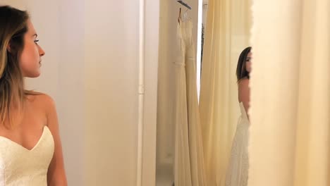 beautiful woman trying on wedding dress in a shop