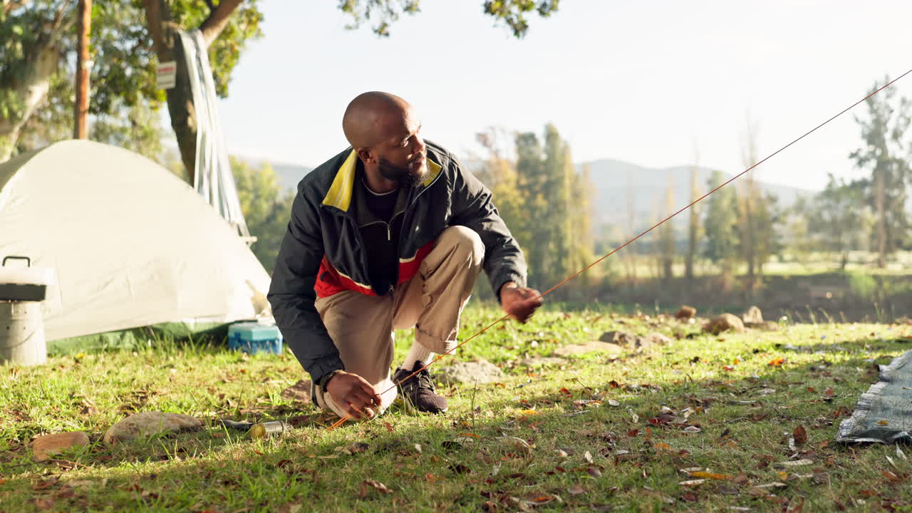 Camping, tent in ground and black man setup