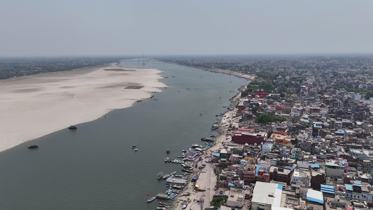 Overhead capture of the densely populated heart of Varanasi, where narrow lanes wind through a maze of colorful buildings and ancient temples.