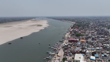 overhead capture of the densely populated heart of varanasi, where narrow lanes wind through a maze of colorful buildings and ancient temples.