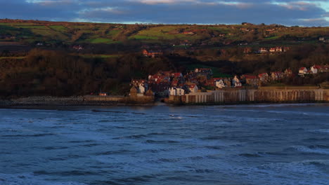 wide angle drone shot of robin hood's bay at sunrise north yorkshire uk