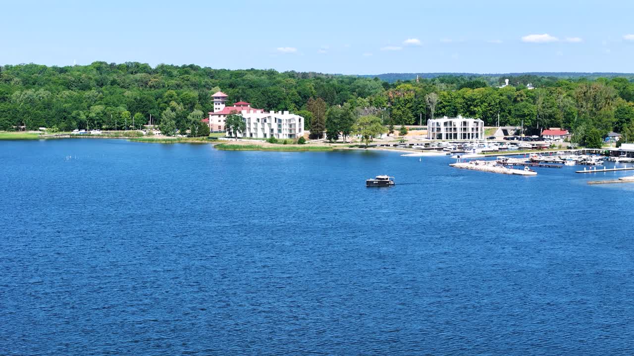 Luxury yacht with Gizycko cityscape in background, aerial view
