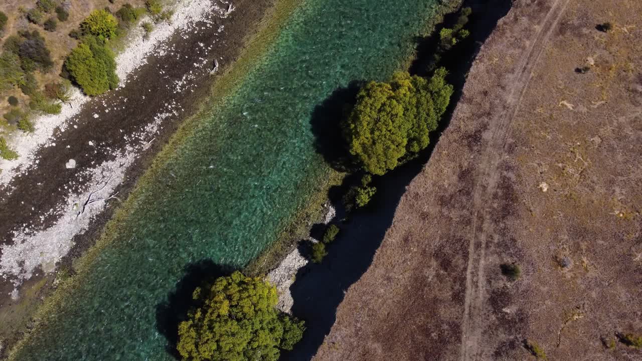 AERIAL Ascending Shot of Turquoise River cutting through a Dry Valley in Otago, New Zealand
