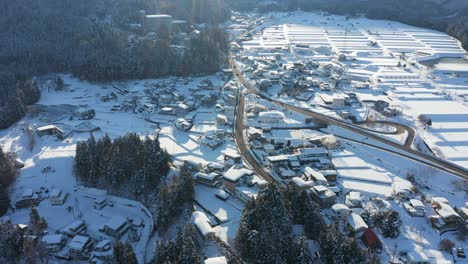 yamanouchi covered in snow, sun rising over the nagano landscape, japan