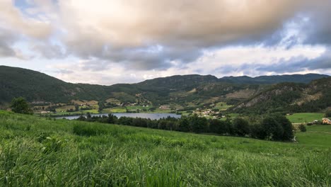 timelapse of beautiful sunset seen from a green field in the country side of norway