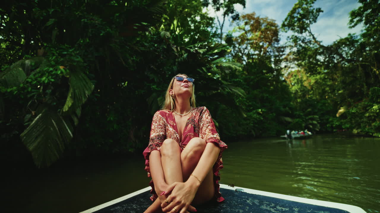 Close up shot of young female traveler enjoying the green lush vegetation of Tortuguero National Park in Costa Rica.