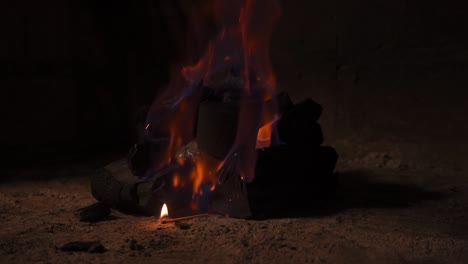 coal being lit in slow motion by a thrown match