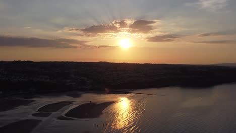 Golden-heavenly-sunset-rays-aerial-view-reflected-over-romantic-exotic-beach-coastline-drift-right