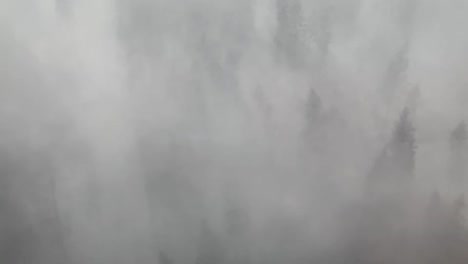aerial view of blizzard in the mountains. whiteout conditions. heavy winds and snowfall.