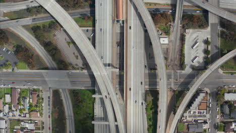 AERIAL:-Spectacular-Overhead-follow-Shot-of-Judge-Pregerson-Interchange-showing-multiple-Roads,-Bridges,-Highway-with-little-car-traffic-in-Los-Angeles,-California-on-Beautiful-Sunny-Day