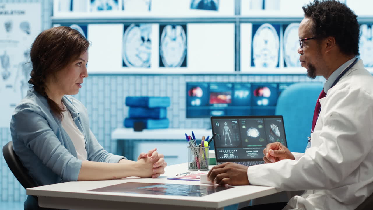 Expert evaluating diagnostic results with a patient in a medical cabinet