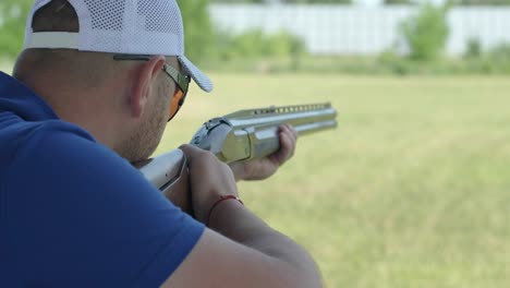 sportsman shoots from a double-barreled shotgun, a sports field for a shooting test is shooting at flying skeet