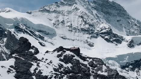 circling descent around alpine hut with jungfrau mountain in the background