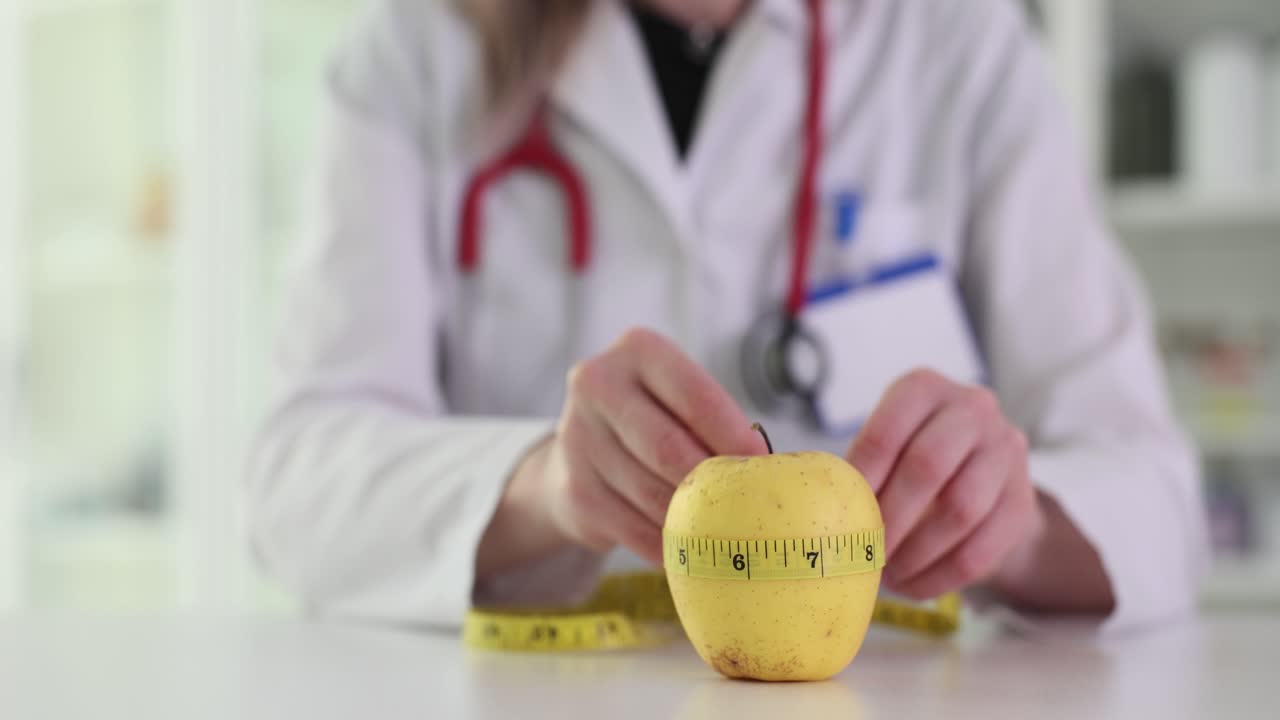 Doctor measuring an apple