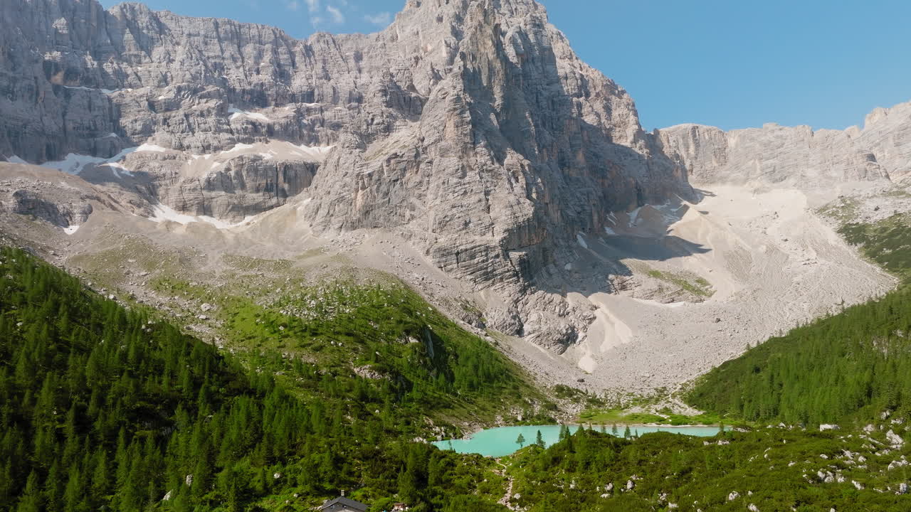 Aerial drone reveal shot of glacial lake, Lago Di Sorapiss in the Dolomites, Italian Alps