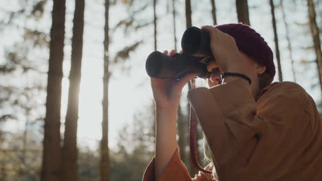 carefree female tourist observing through binoculars