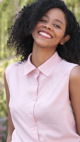 cheerful woman wearing pink sleeveless shirt in city during daytime