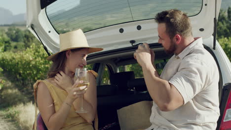 a young man taking photos of his girlfriend