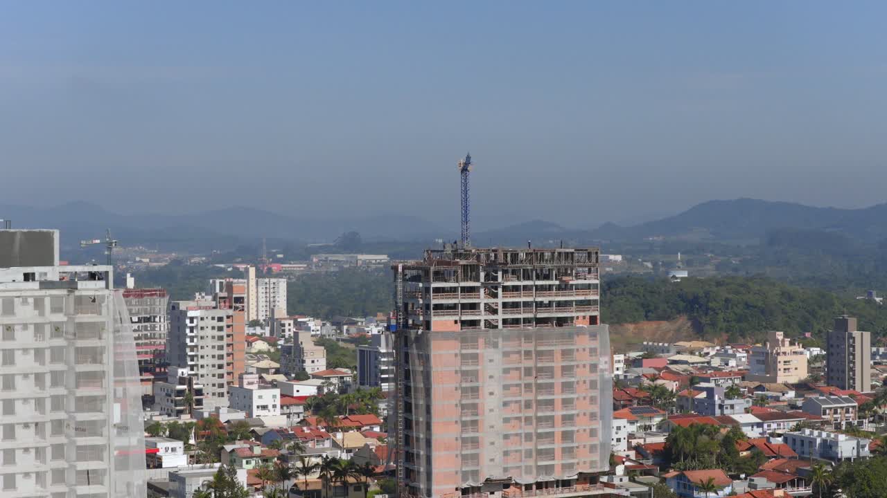 Editorial aerial view of a construction site high-rise building in Balneário Piçarras, Santa Catarina, Brazil