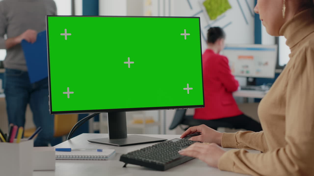 Close up of employee using green screen on monitor