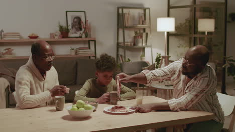 Black-men-and-boy-eating-dinner-at-home