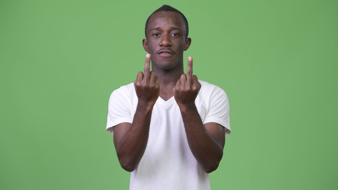 Young African man showing two middle fingers