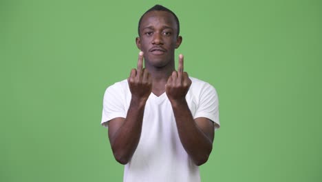 young african man showing two middle fingers