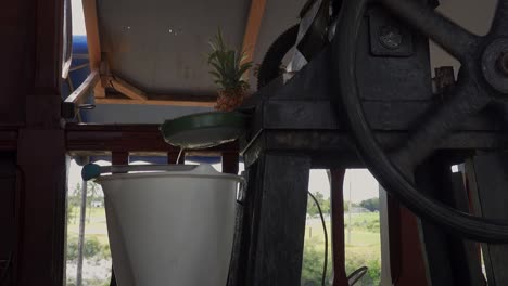 sugar cane juice pressed on an old press machine for making a beverage