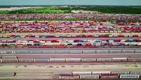 a vibrant mosaic of shipping containers and rail cars, immense scale of modern intermodal freight operations