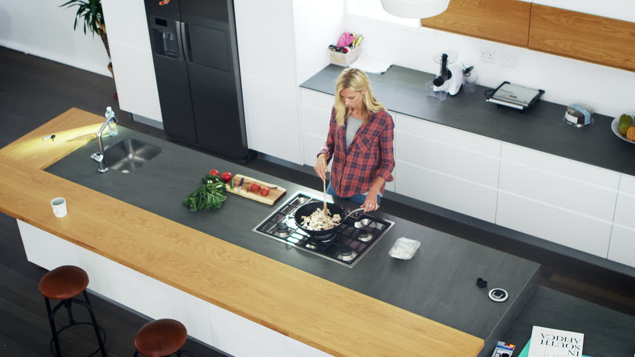 Overhead View Of Woman Preparing Meal Modern Kitchen