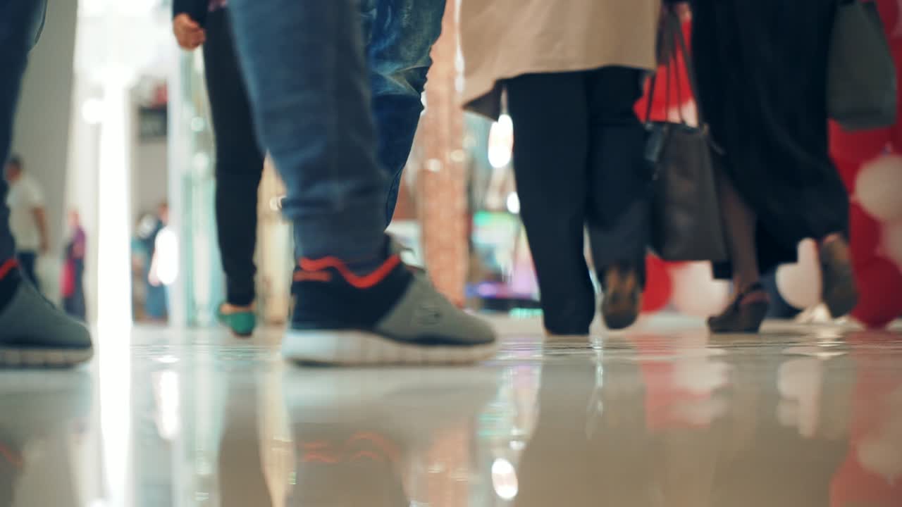 People walking in a shopping center. Close-up of feet. Shopping time.