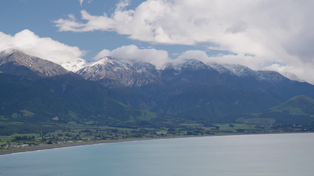 The Manakau mountains above Kaikoura, New Zealand with the ocean and a cloudy sky