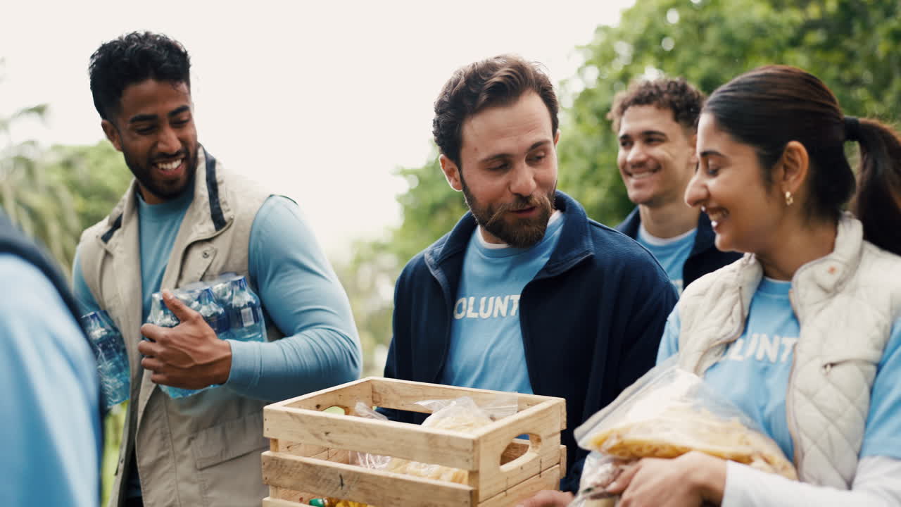 Happy Diverse Group of Volunteers Preparing Food Donations Outdoors