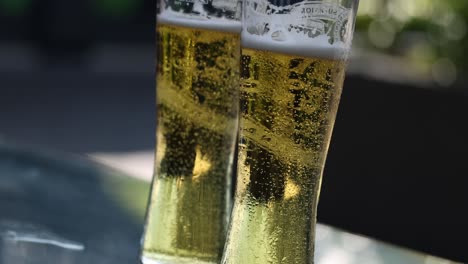 close-up of a beer glass with bubbling foam