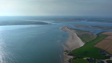 saltmills, county wexford, ireland, september 2024. drone counterclockwise orbit around bannow island beach, capturing bannow bay as the sunshine illuminates the shimmering irish coastline.