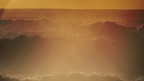 large dark waves roll into the coast of hawaii and crash into the shore in slow motion during a big storm