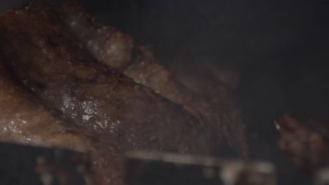 brazilian barbeque meat on a skewer rotating, smoking in a grill