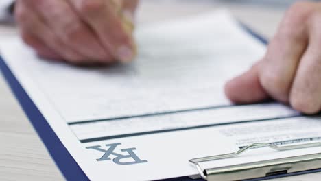 unrecognizable man writing on document