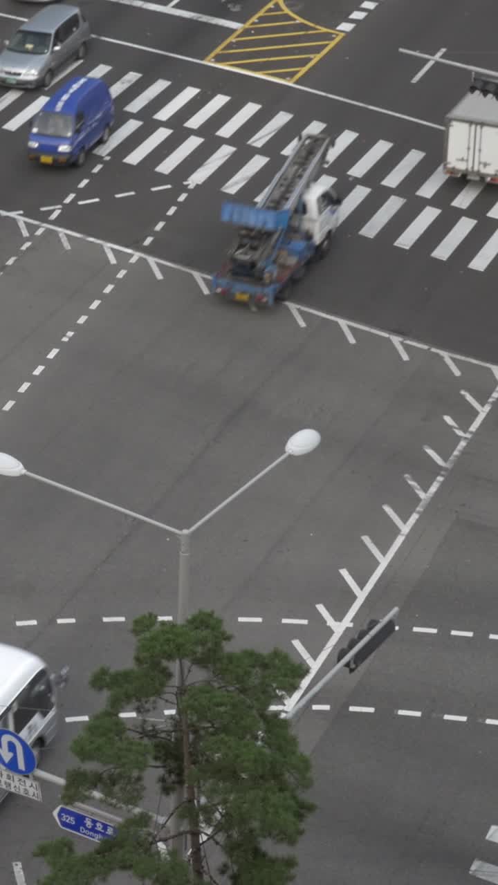 High Angle View of Busy City Intersection with Moving Traffic and Pedestrians