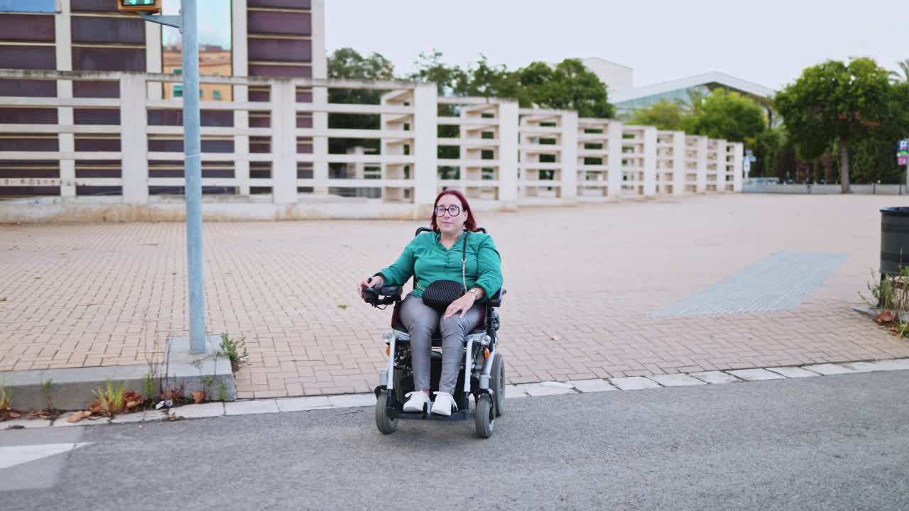Happy Woman in Electric Wheelchair Crossing Urban Street