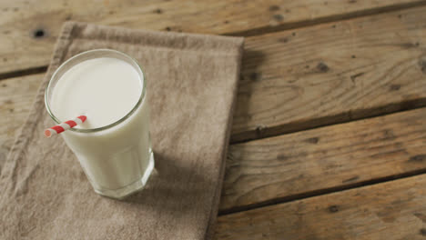 video of glass of fresh milk on wooden background