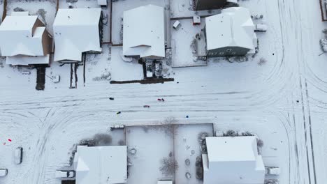 Top-down-aerial-view-of-kids-playing-in-snow-covered-streets