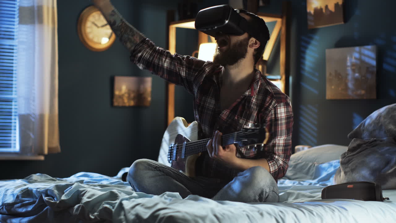 Man Playing Guitar with VR Headset in Bedroom