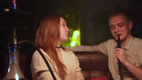 couple enjoying hookah in a lounge