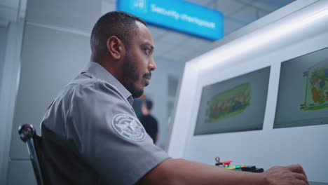 airport security guard monitoring x-ray scan