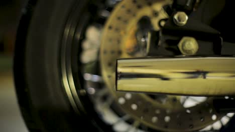 Close-up-of-a-rattling-exhaust-pipe-with-smoke-indicating-the-engine-starting-up